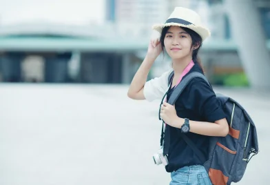 smiling-woman-walking-outdoors-young-lady-admiring-city-sight-with-walkway-buildings-background_11zon